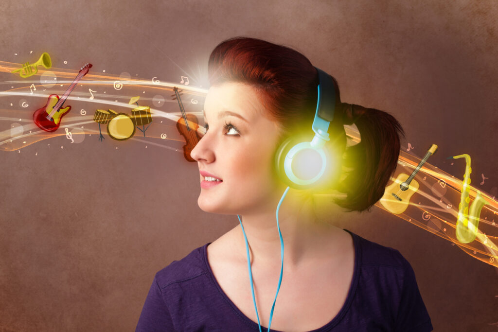 Pretty young woman with headphones listening to music, instruments concept